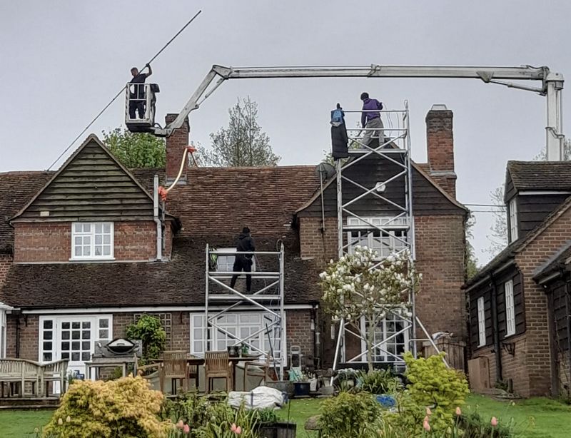 The Roof Moss Cleaners using cherry picker and scaffolding to clean roof safely and professionally in Linton, Cambridgeshire